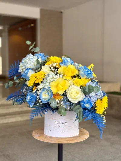 Luxury hat box with roses chrysanthemums hydrangeas and green leaves