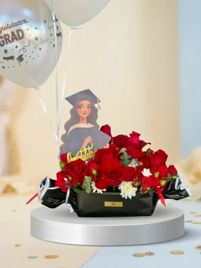 Black graduation flower box with red flowers and white balloons