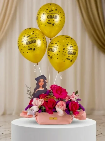 Pink graduation flower box with yellow balloons UAE